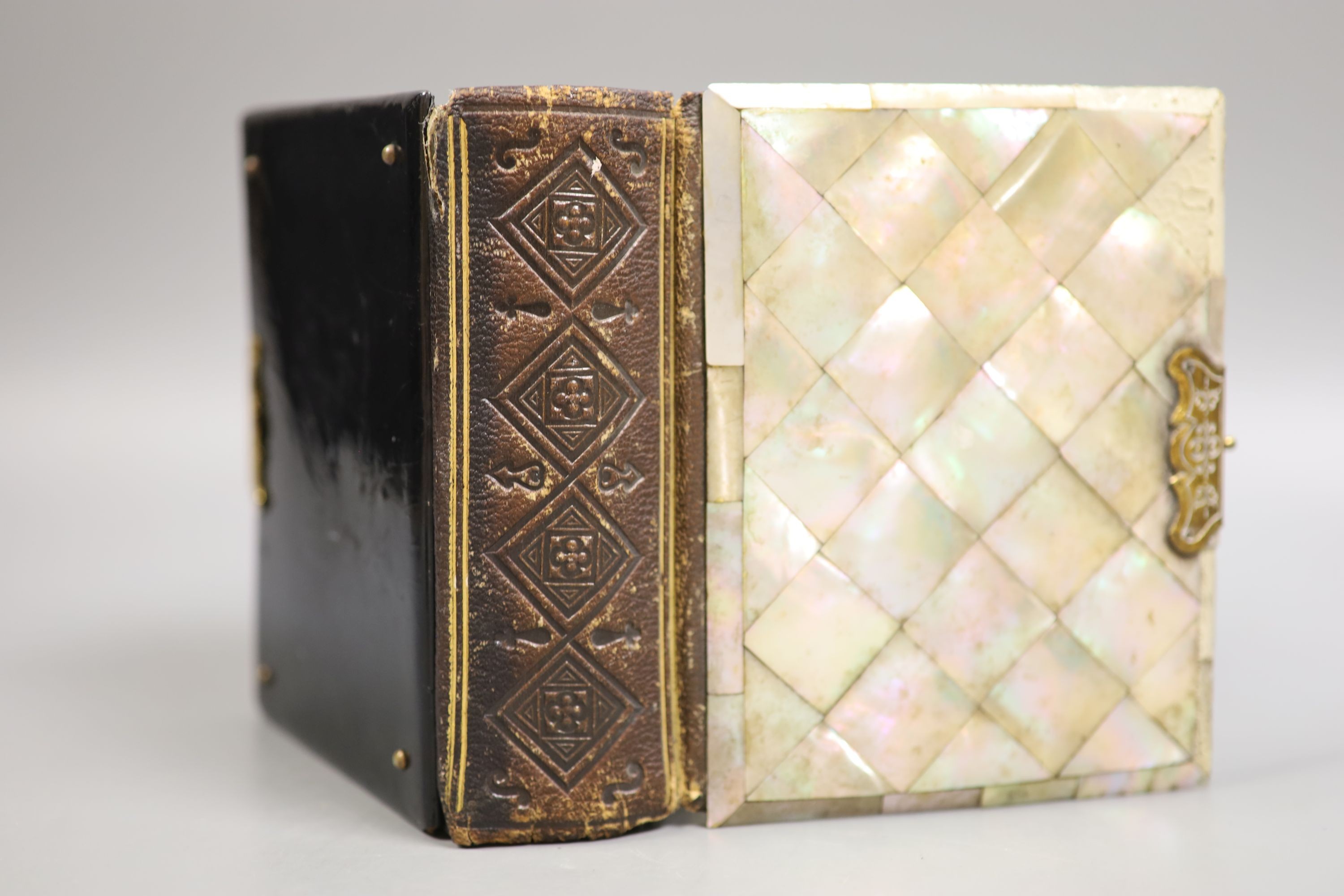 Three Victorian mother of pearl card cases, a papier mache card case and a mother of pearl bound book